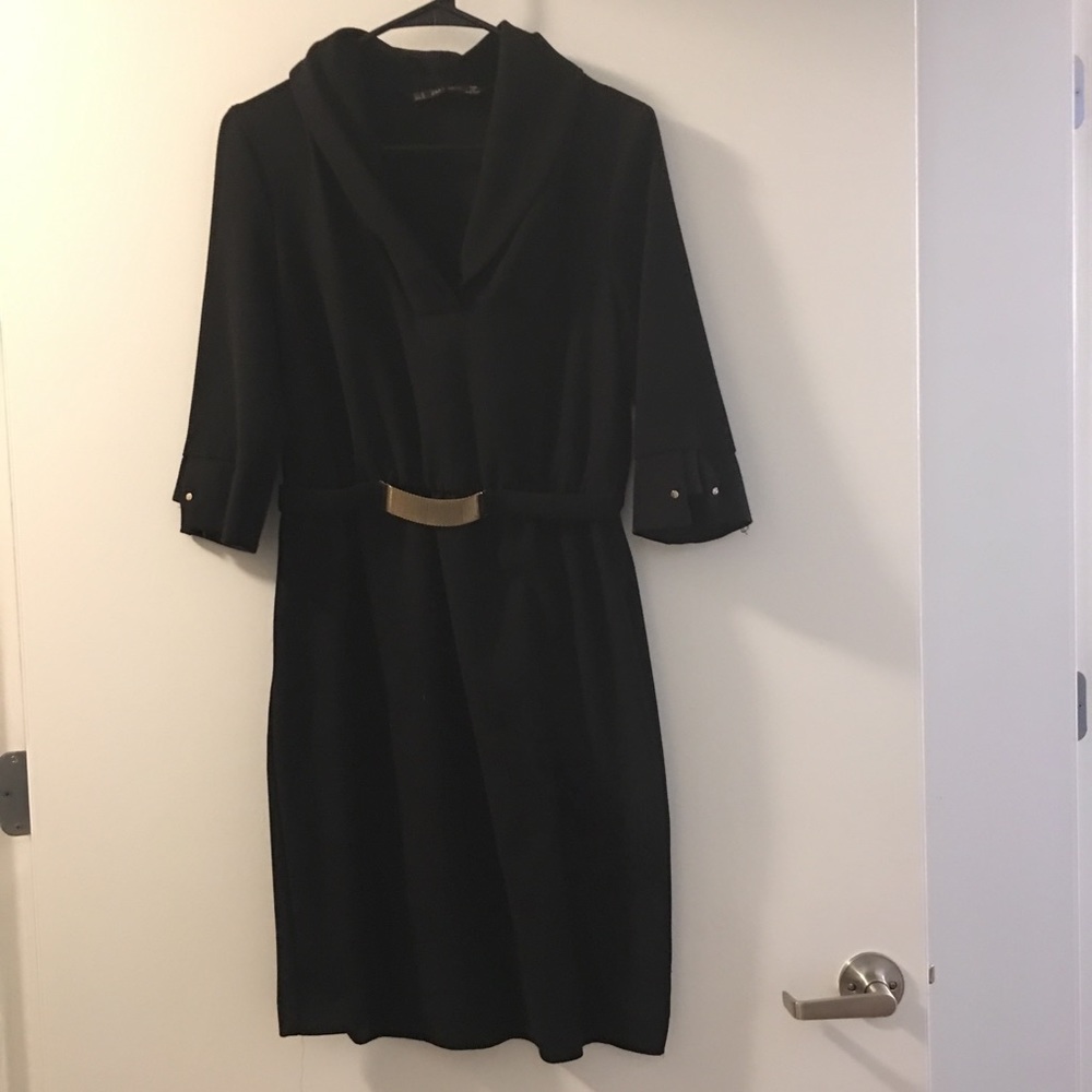 Above knee black dress with gold details.